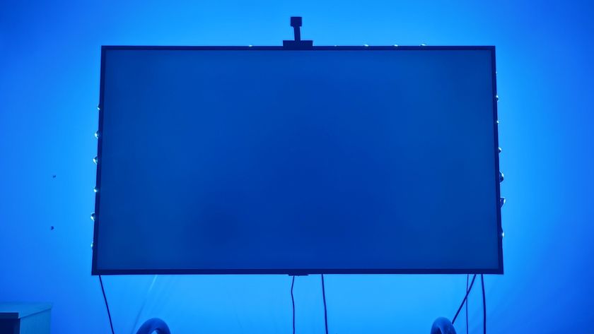 A TV with a blue screen with an LED lightstrip emitting blue light 