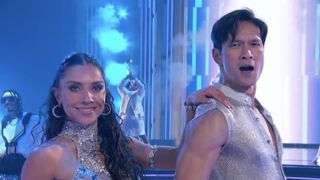 Harry Shum Jr. and Jenna Johnson hitting their last pose in silver costumes during DWTS Super Bowl night. 