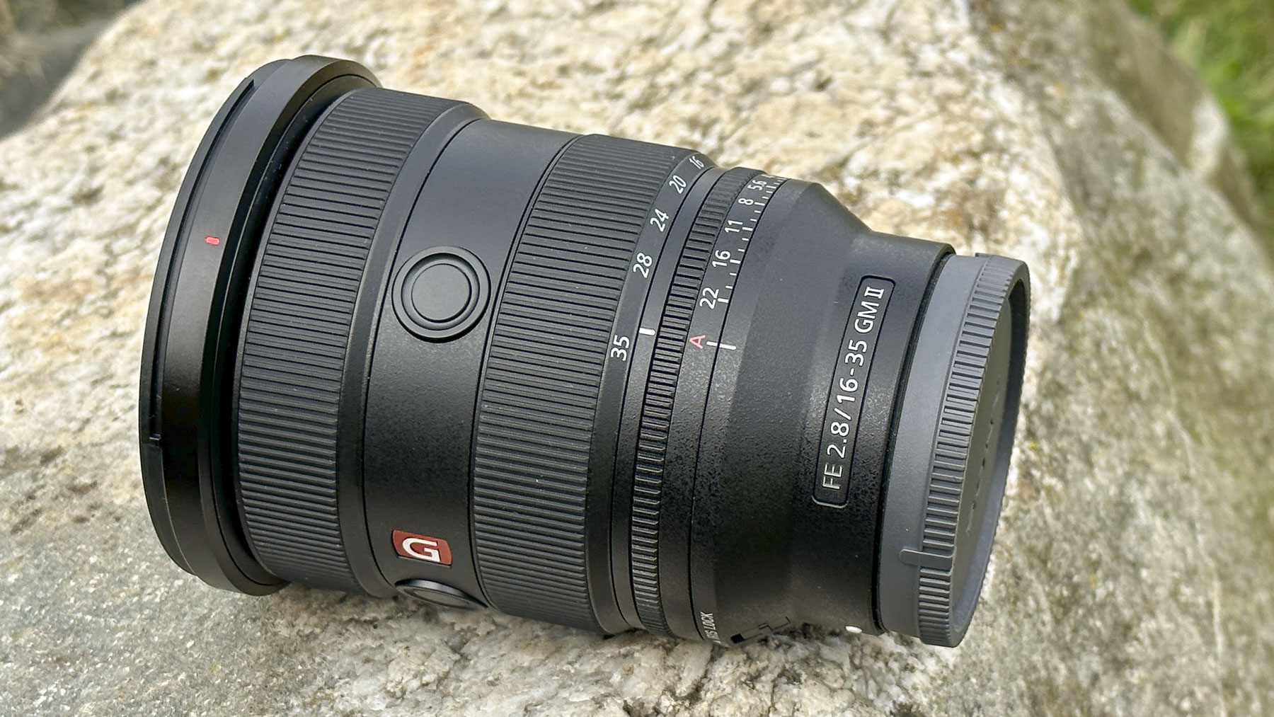 Sony FE 16-35mm F2.8 GM II lens outdoors on a rock