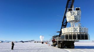 Researchers prepare to launch the Antarctic Impulsive Transient Antenna (ANITA) experiment, which picked up signals of impossible-seeming particles as it dangled from its balloon over Antarctica.