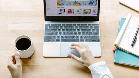 man working on laptop on desk