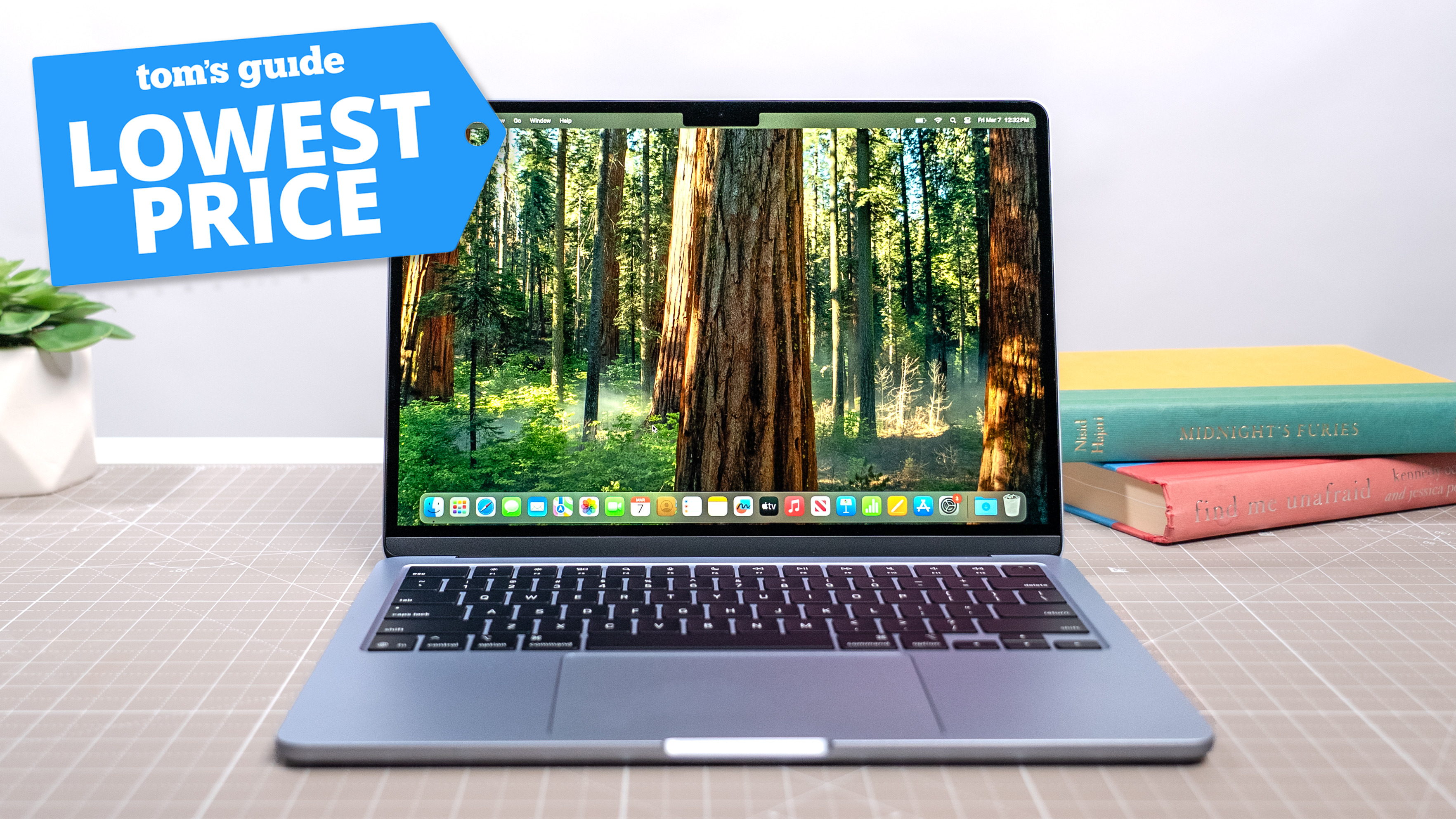 M4 MacBook Air open on table with Tom's Guide Lowest Price badge