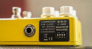 Xotic AC Booster V2: this yellow stompbox has four white dials, external dipswitches and two footswitches