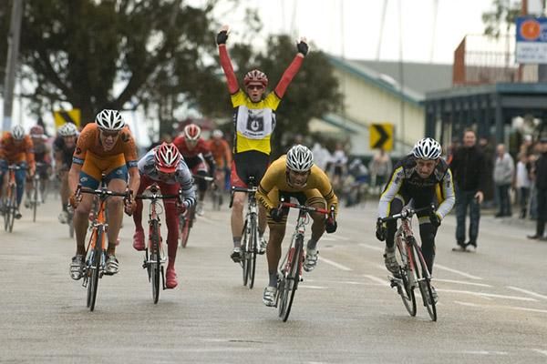 Malaysian Harrif Saleh (second from right) charges towards the finish and the stage victory as tour winner Patrick Shaw begins the celebrations in the background.