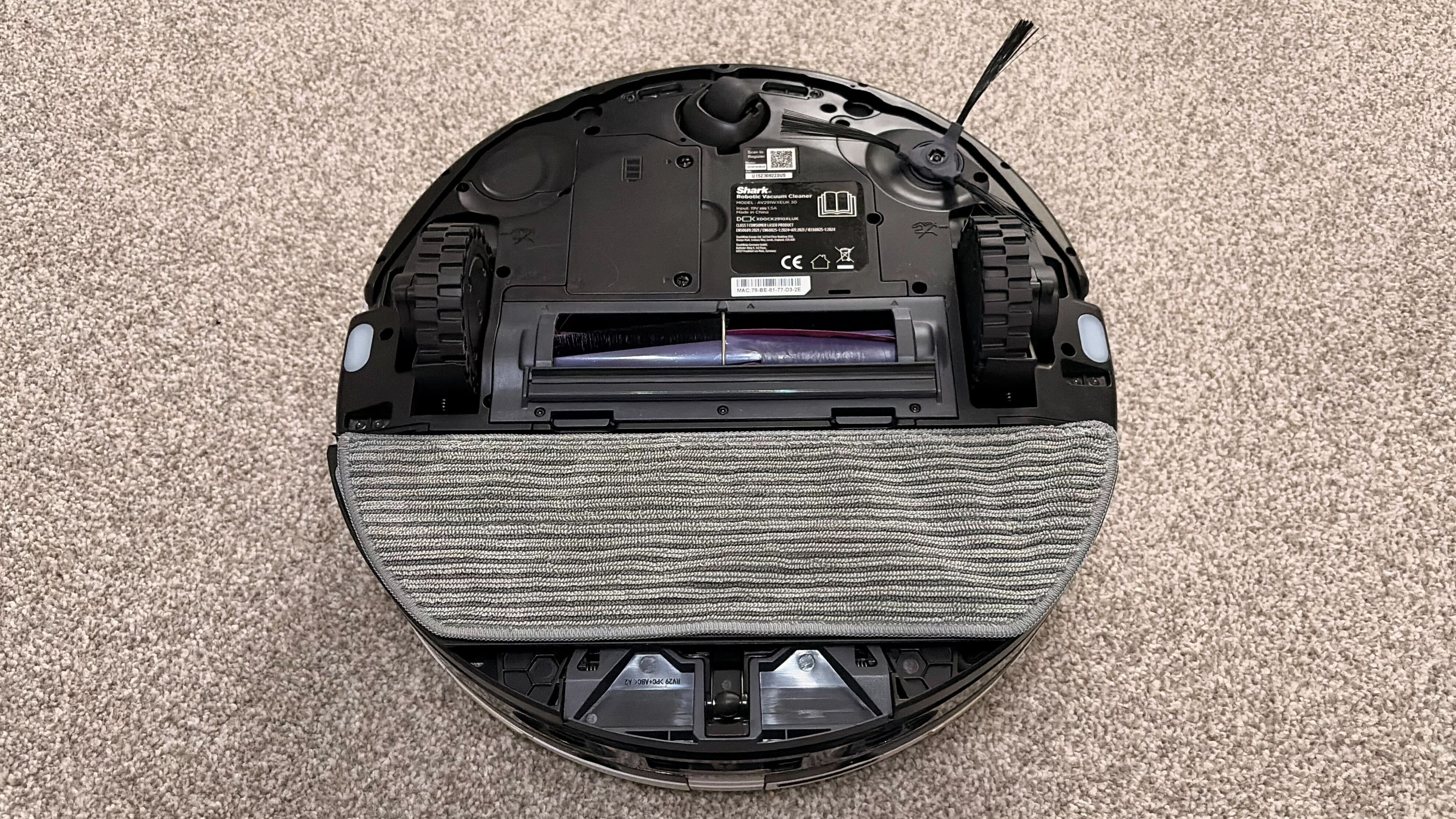 Shark PowerDetect 2-in-1 ThermaCharged NeverTouch photographed on a carpet with docking station