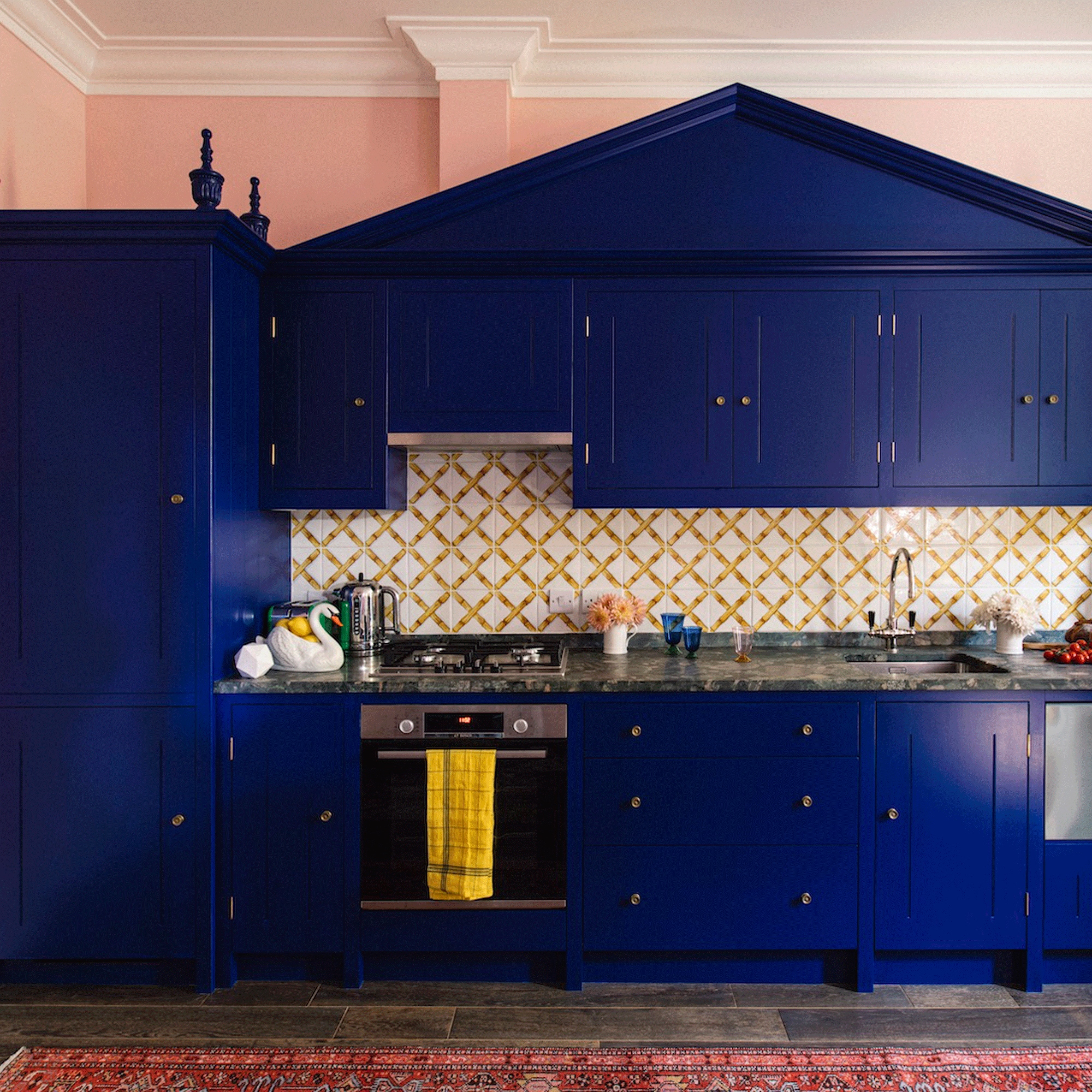 Cobalt blue kitchen with pink rug
