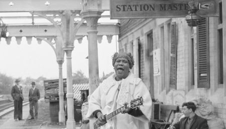 Sister Rosetta Tharpe sings and plays a Gibson SG at Wilbraham Road Station in Manchester, England, while filming the Granada Television special Blues And Gospel Train on May 7, 1964