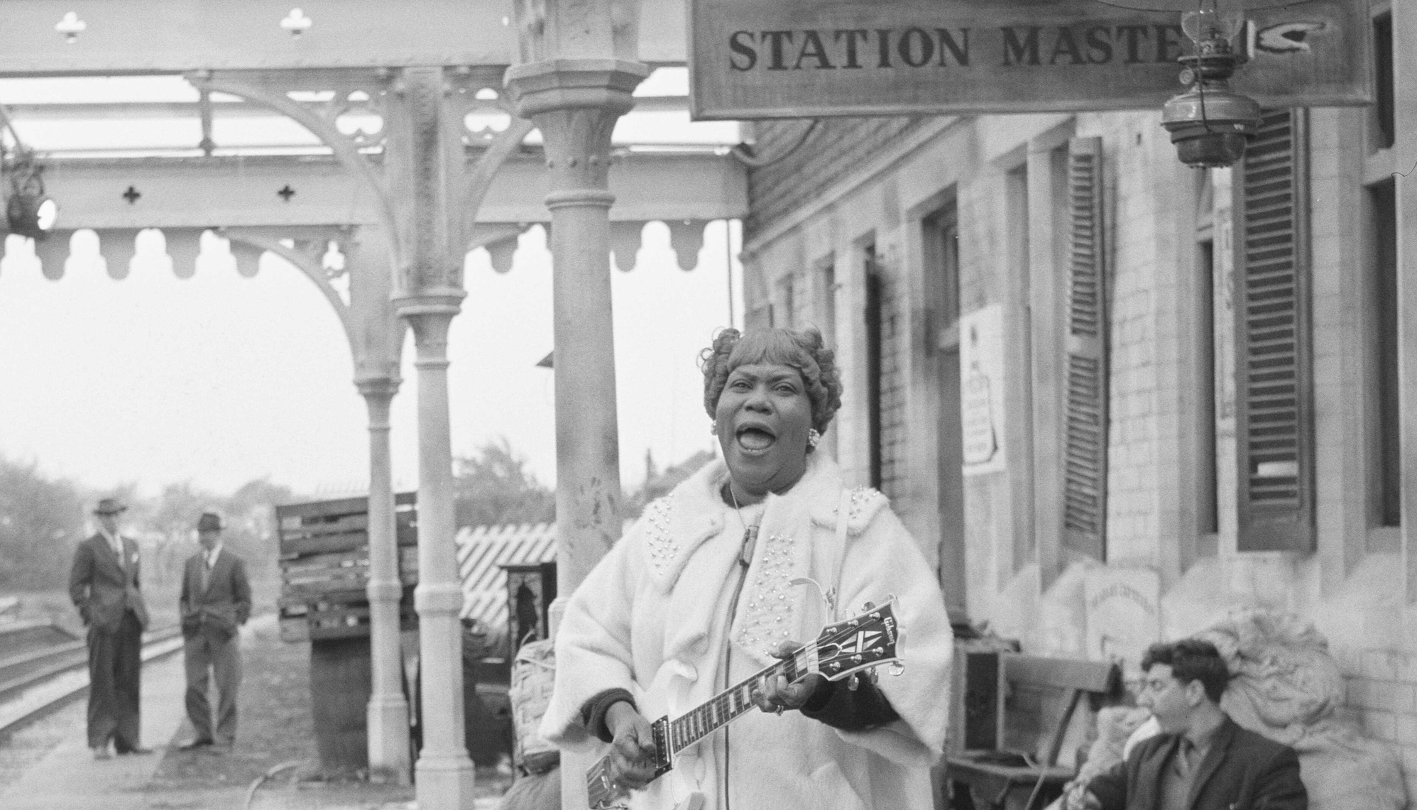 Sister Rosetta Tharpe sings and plays a Gibson SG at Wilbraham Road Station in Manchester, England, while filming the Granada Television special Blues And Gospel Train on May 7, 1964
