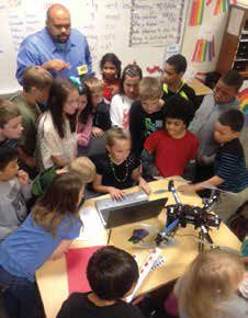 With a Kent ISD STEM consultant, third graders in Kentwood Public Schools program a UAV (drone) for flight.  