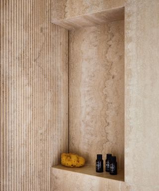 bathroom with grooved details in travertine