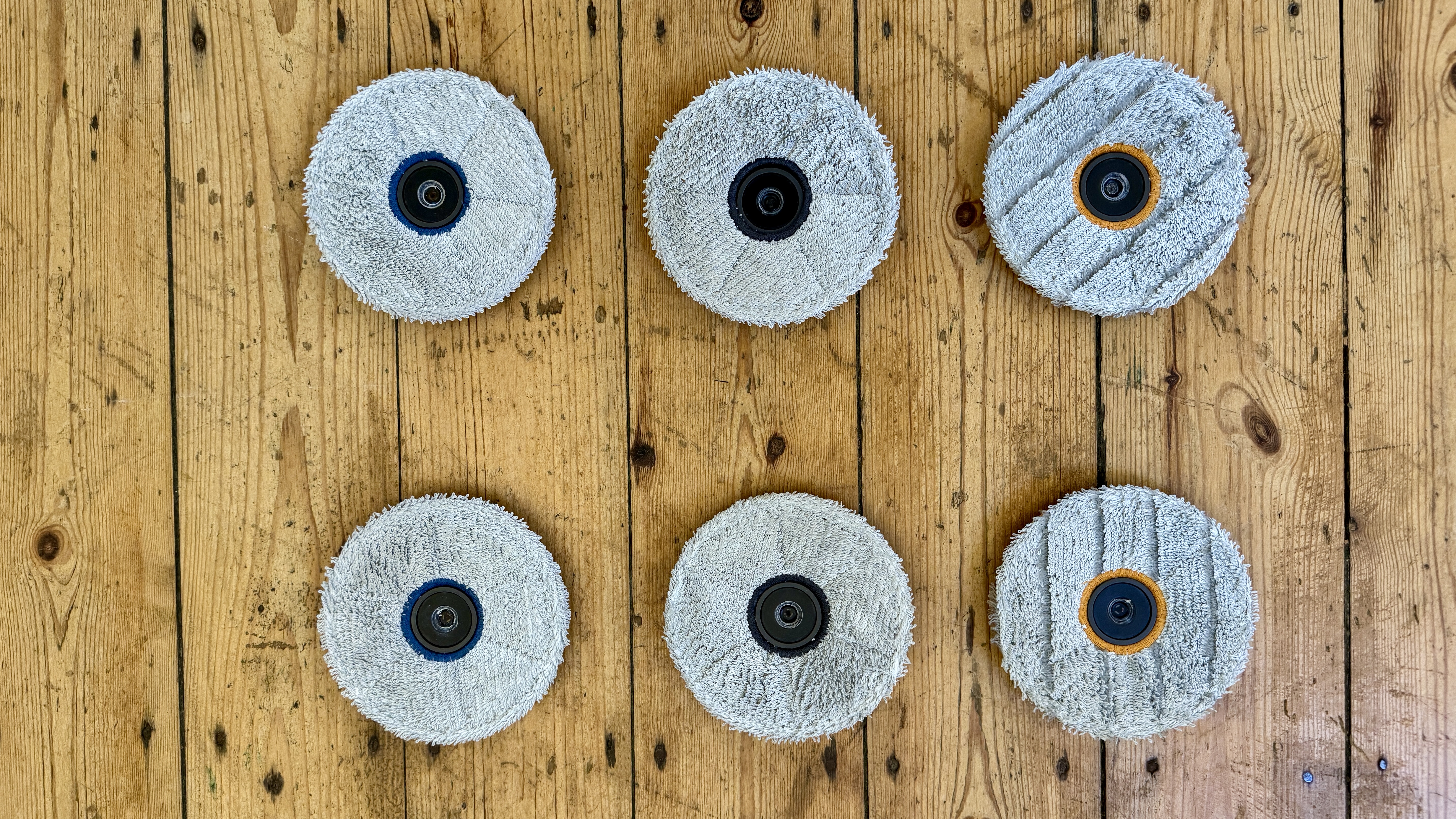 Three sets of mop pads laid out on the floor