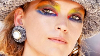 Woman with multi-colored eye makeup.