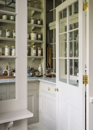 white pantry with labelled storage jars