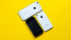 Old iPhones on yellow background