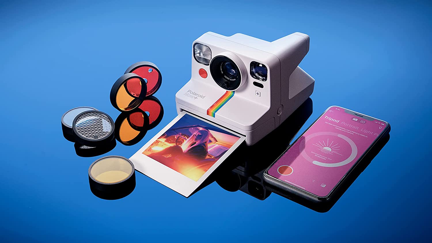 Polaroid Now+ image on blue background with accessories and smartphone app