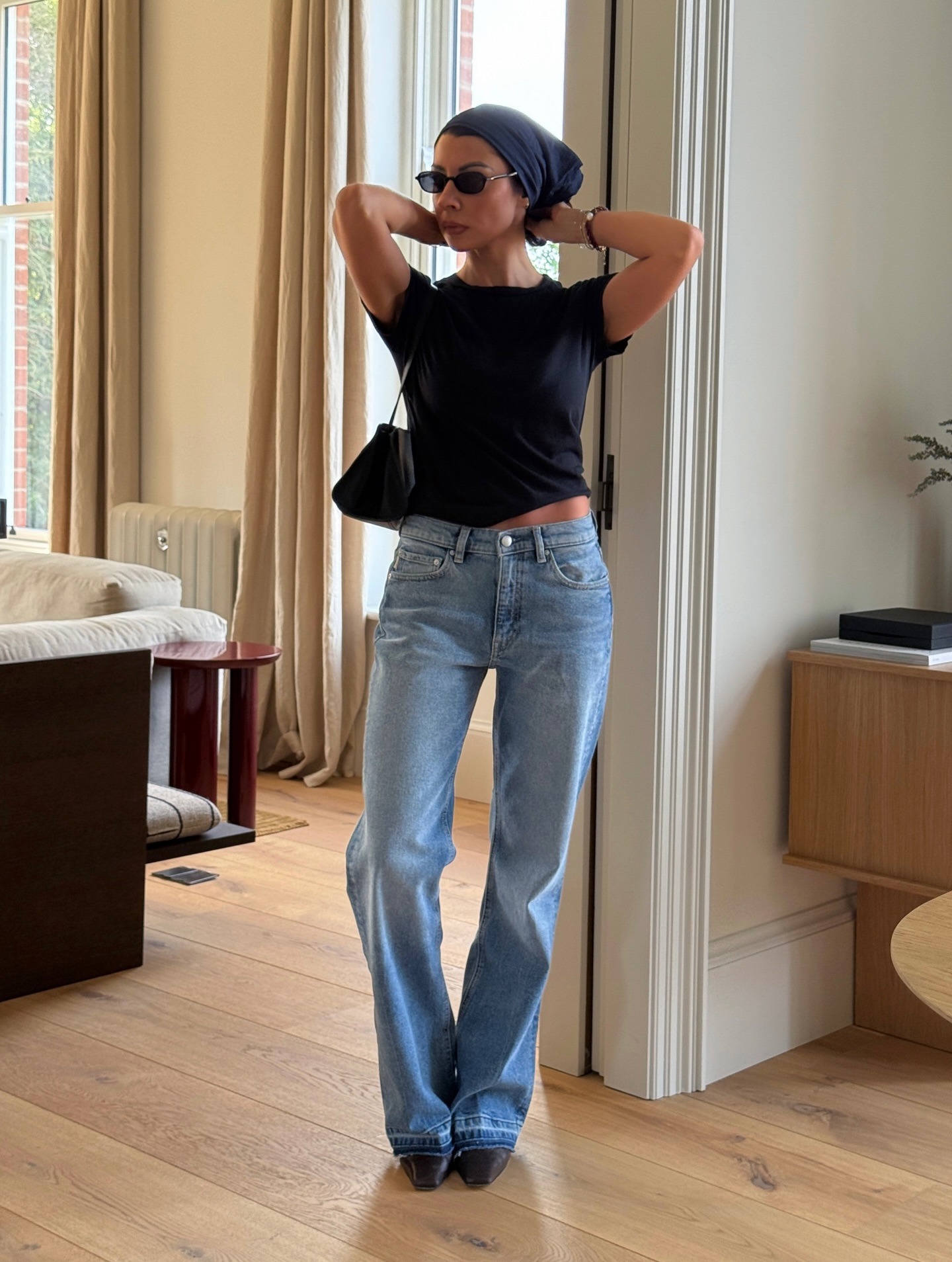 Woman wearing bootcut jeans, a spring 2026 jean trend.