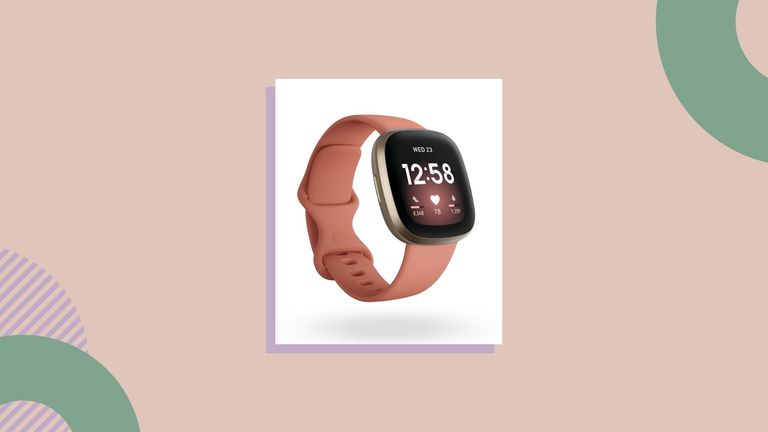 Pink Fitbit Versa 3 on peach background