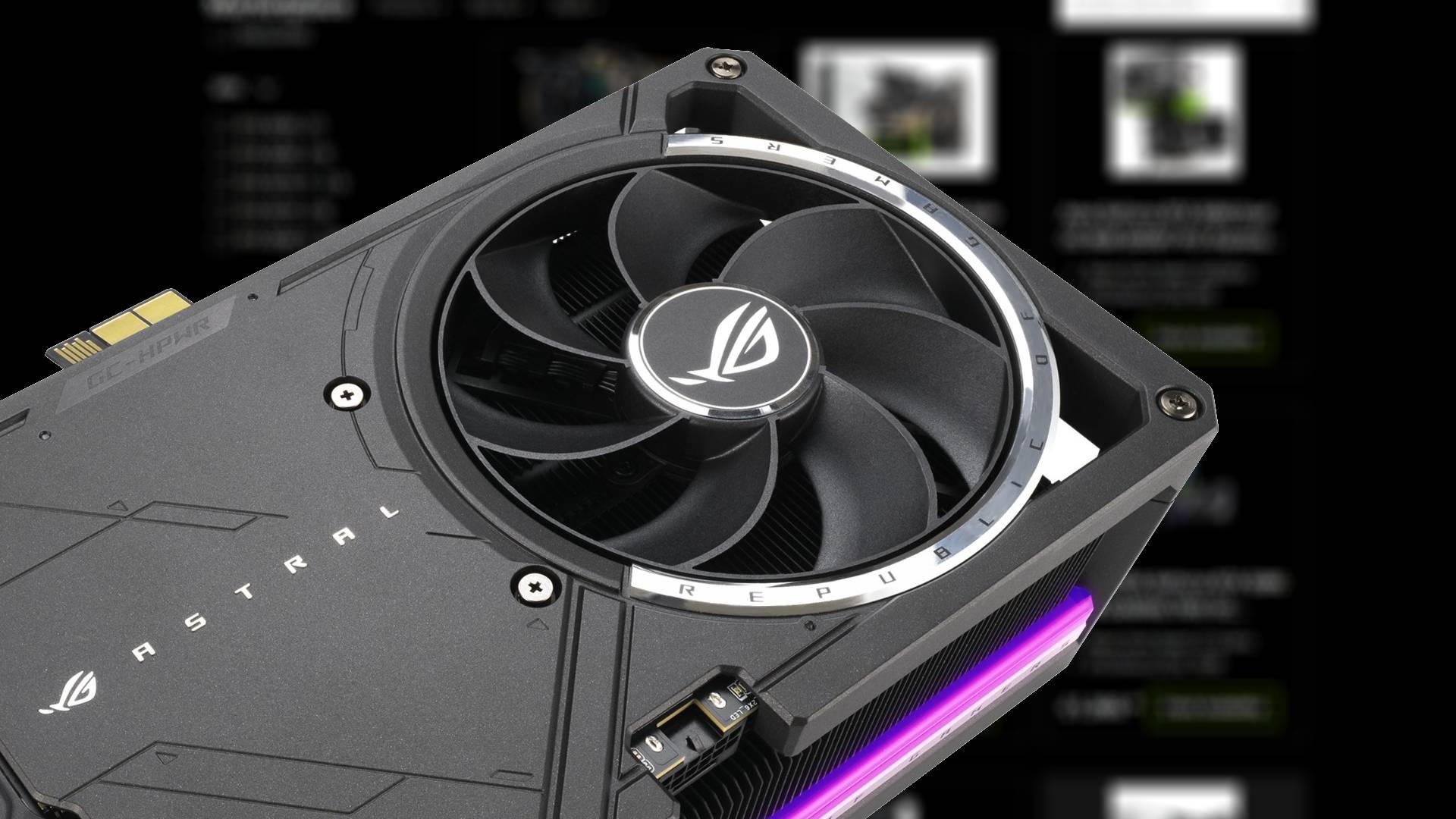 Close up of Asus RTX 5090 Astral GPU with blurred Nvidia storefront in backdrop.
