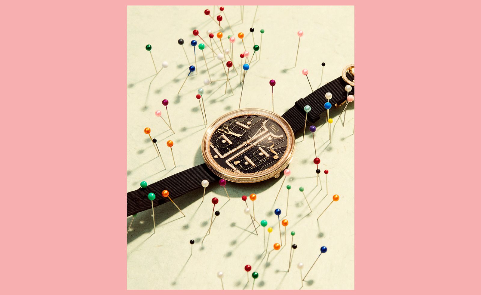 Chanel watch surrounded by pin cushion needles