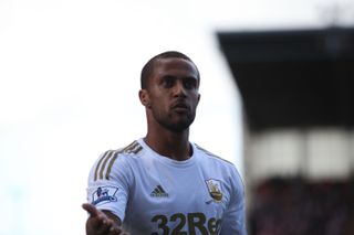 Wayne Routledge gestures while playing for Swansea City against Stoke City, 2012