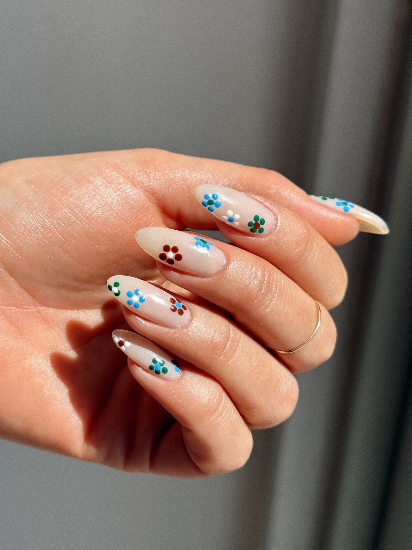 A floral manicure with brown and blue flowers