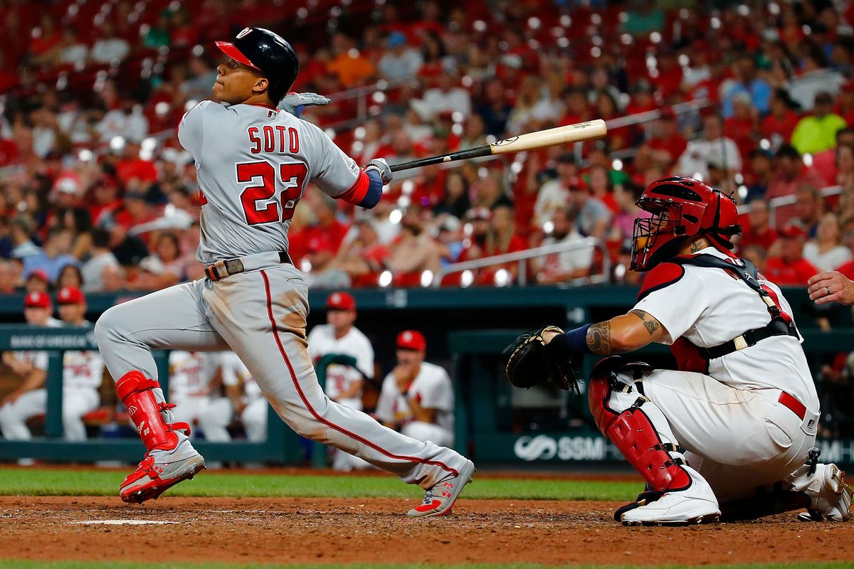 ST LOUIS, MO - SEPTEMBER 17: Juan Soto #22 of the Washington Nationals hits an RBI sacrifice fly against the St. Louis Cardinals in the ninth inning at Busch Stadium on September 17, 2019 in St Louis, Missouri.