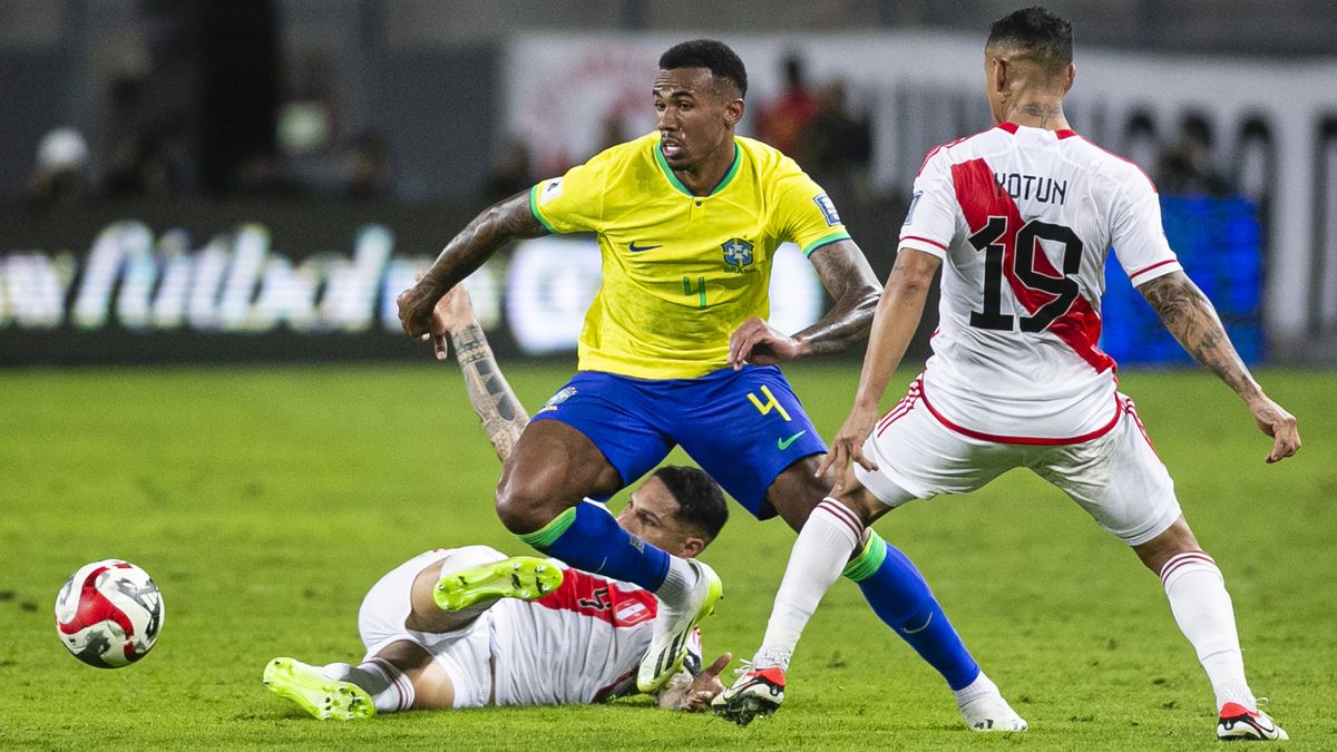 Gabriel (L), takes the ball out of danger, wearing the yellow and blue of Brazil, during Brazil vs Peru.