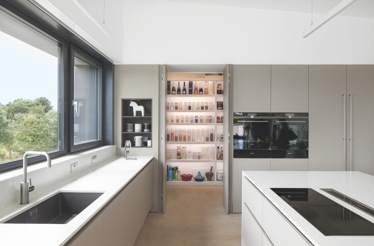lit up kitchen pantry behind cupboards
