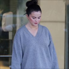 Selena Gomez wearing an oversize Reformation sweater while leaving the Rare Beauty offices