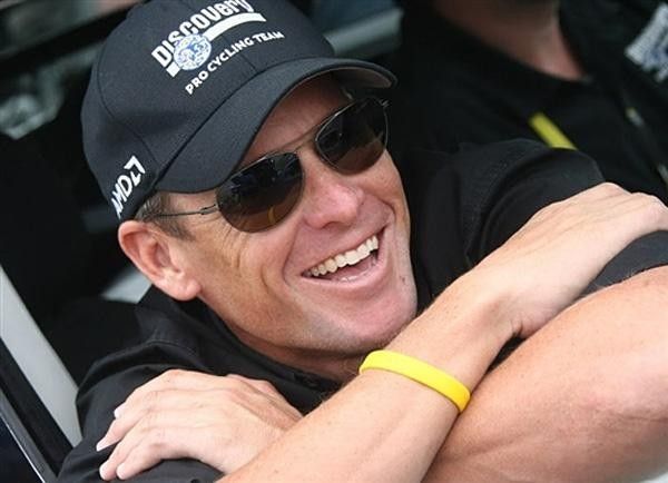 Lance Armstrong watches on during the final stage as his Discovery Channel team completes a successful Tour de France.