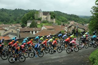 The pack rides during the second stage of the 76th edition of the Criterium du Dauphine cycling race, 142km between Gannat and Col de la Loge, near La Chamba, central France, in ChÃ¢teldon on June 3, 2024. (Photo by Thomas SAMSON / AFP)