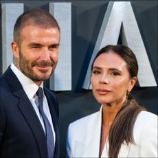 Victoria Beckham poses with her husband, David Beckham.