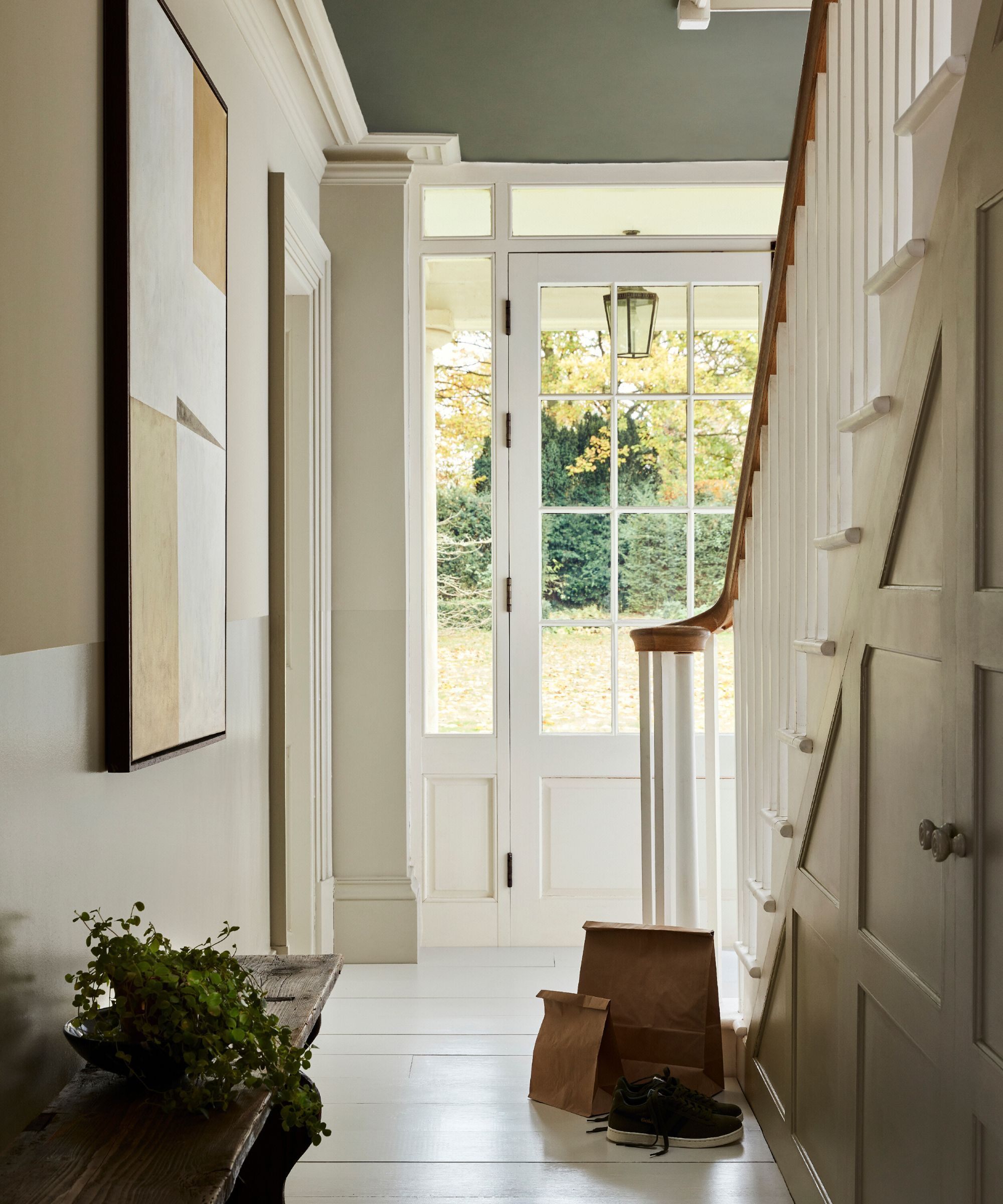 A light filled hallway painted in various neutral tones