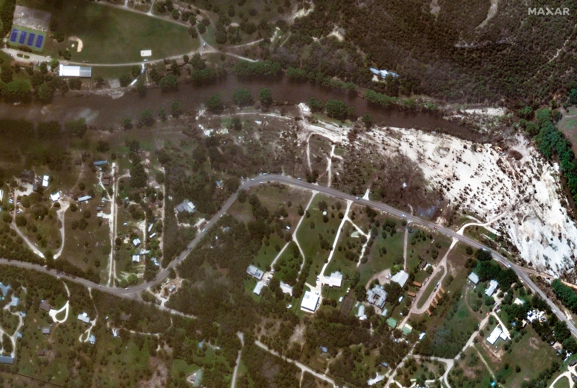 A satellite photograph revealing that homes have been washed away in flooding along the Guadalupe River on July 8.