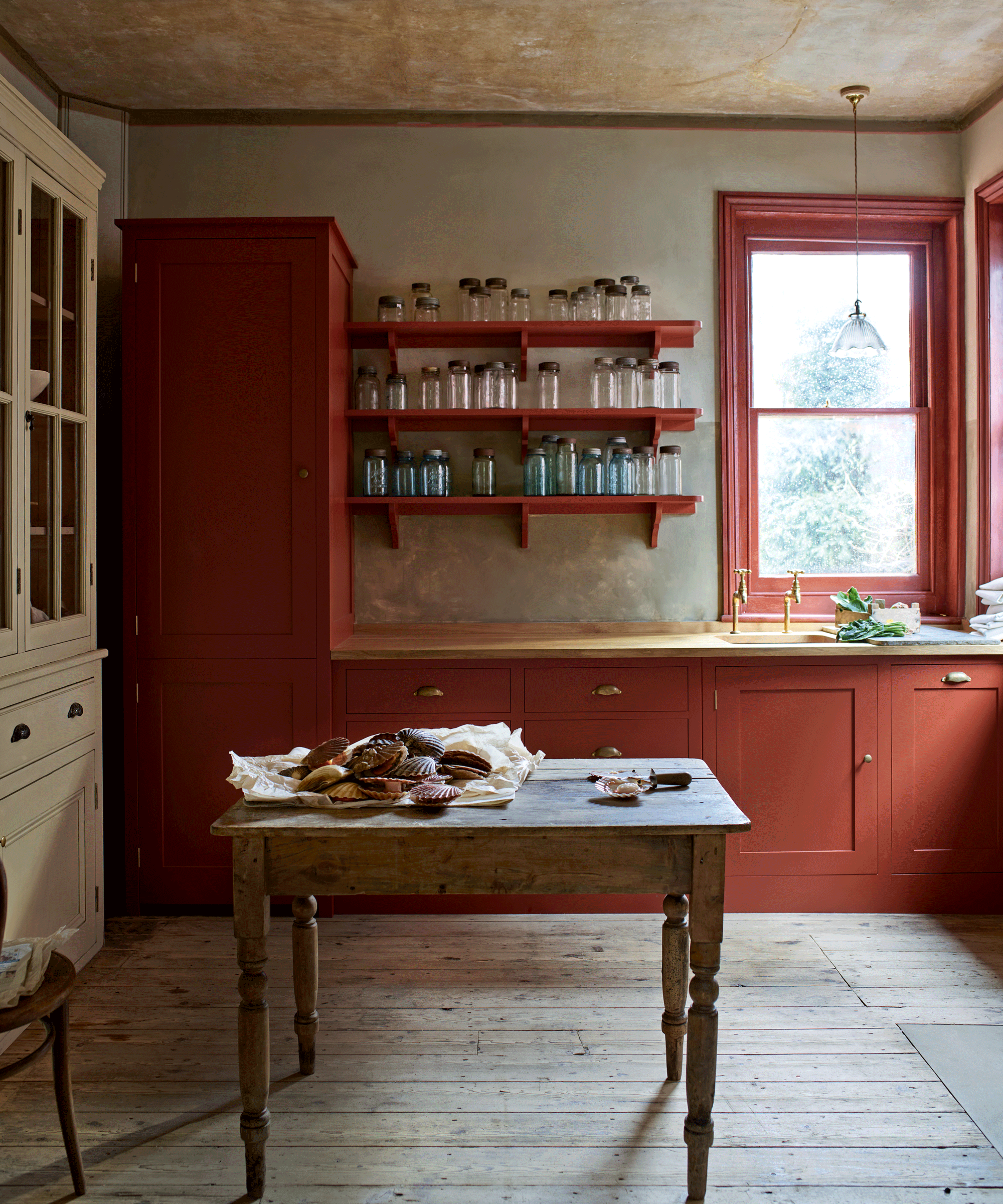 Red country kitchen with farmhouse table