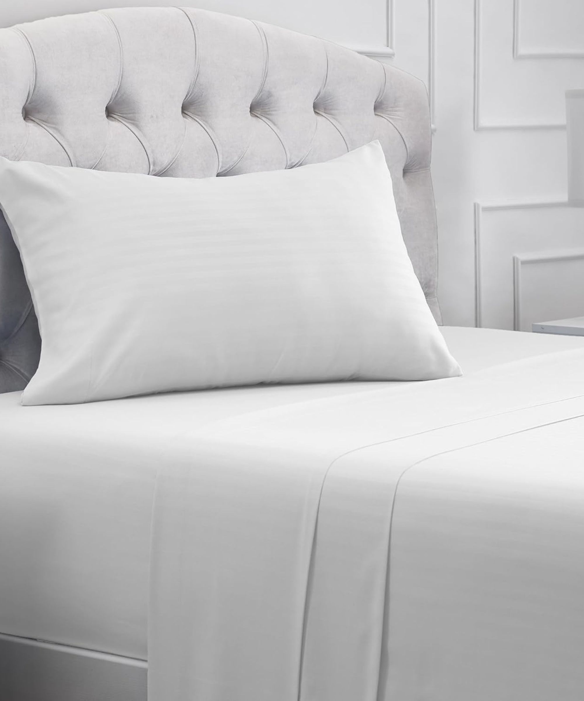 White panelled bedroom with striped white bedding