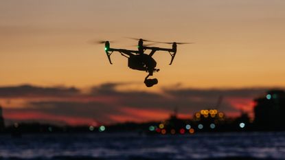 Drone flying and taking pictures of sunset skyline