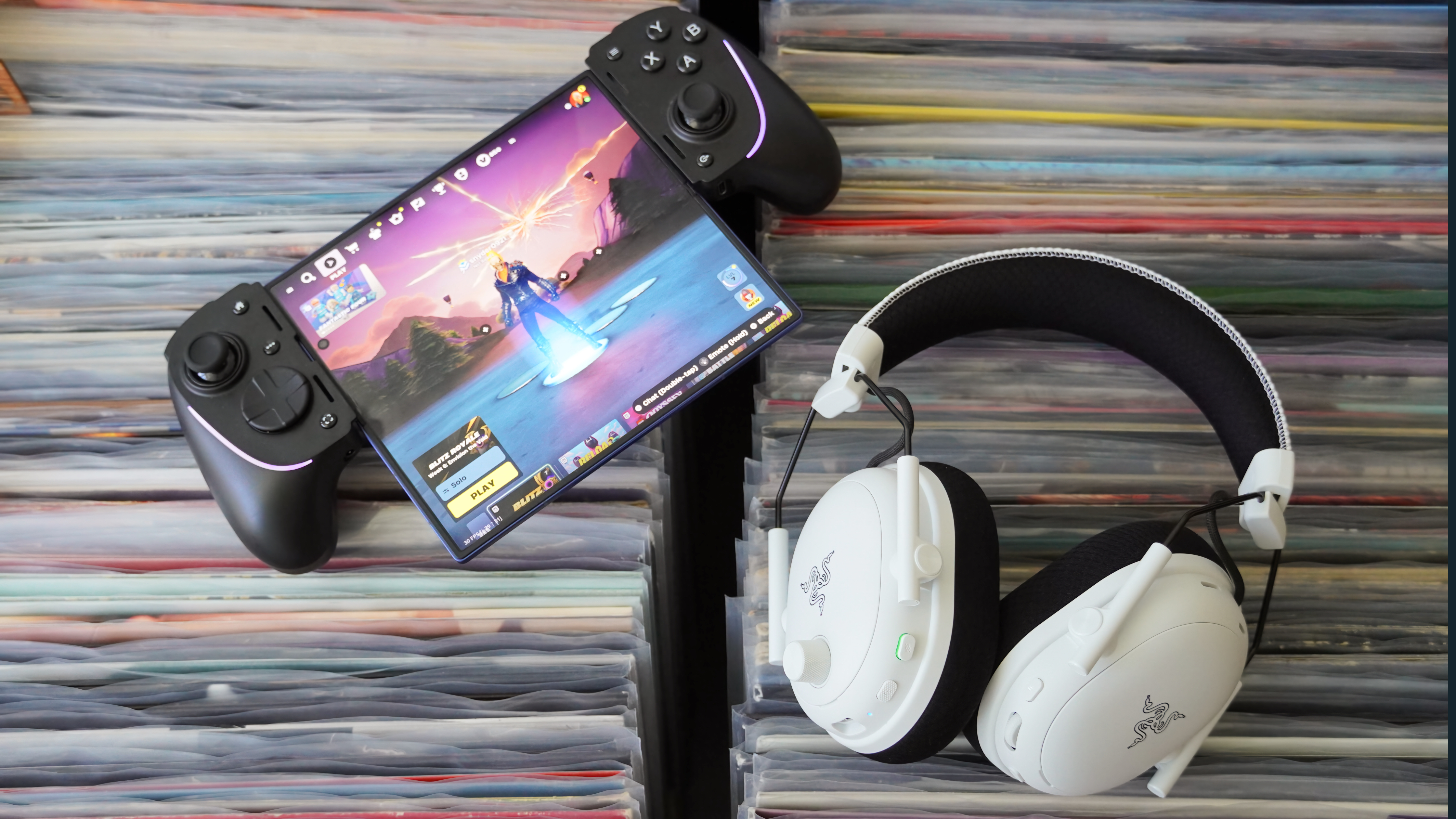 The Razer BlackShark V3 Pro gaming headset laid atop records next to a Z Fold 7.