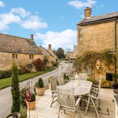 terrace with plants and wooden table and chairs