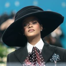 Rihanna wearing a large black top hat at the Met Gala