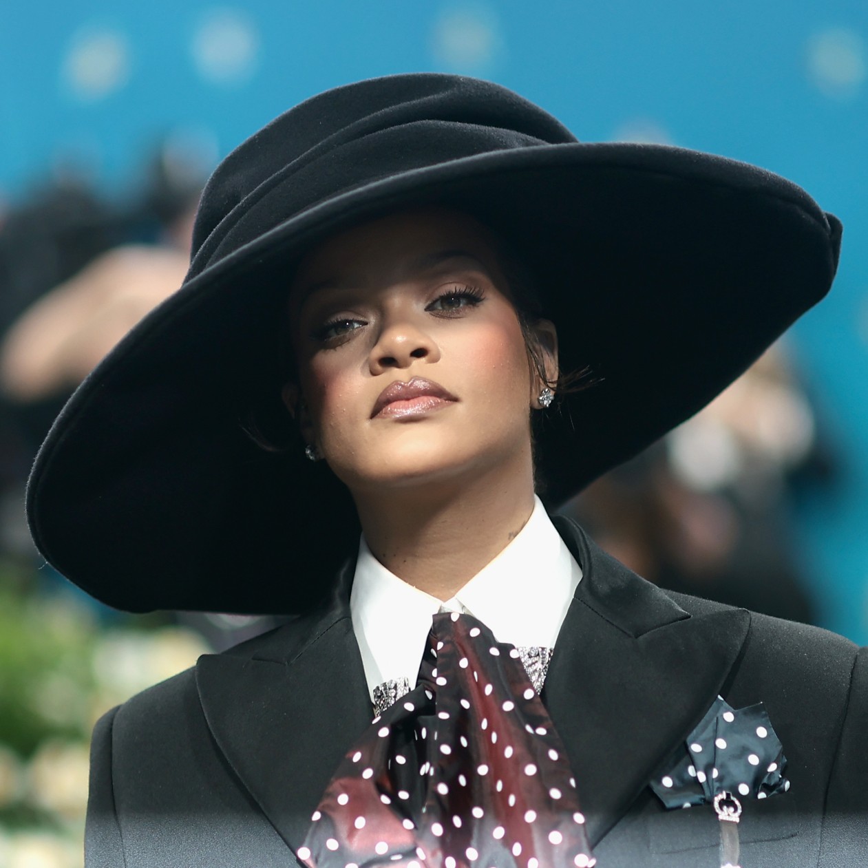 Rihanna wearing a large black top hat at the Met Gala
