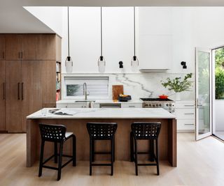 kitchen island with marble countertop and wooden cabinetry