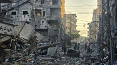 People inspect the site of an Israeli strike in the southern Lebanese coastal city of Tyre 