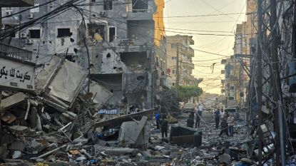 People inspect the site of an Israeli strike in the southern Lebanese coastal city of Tyre