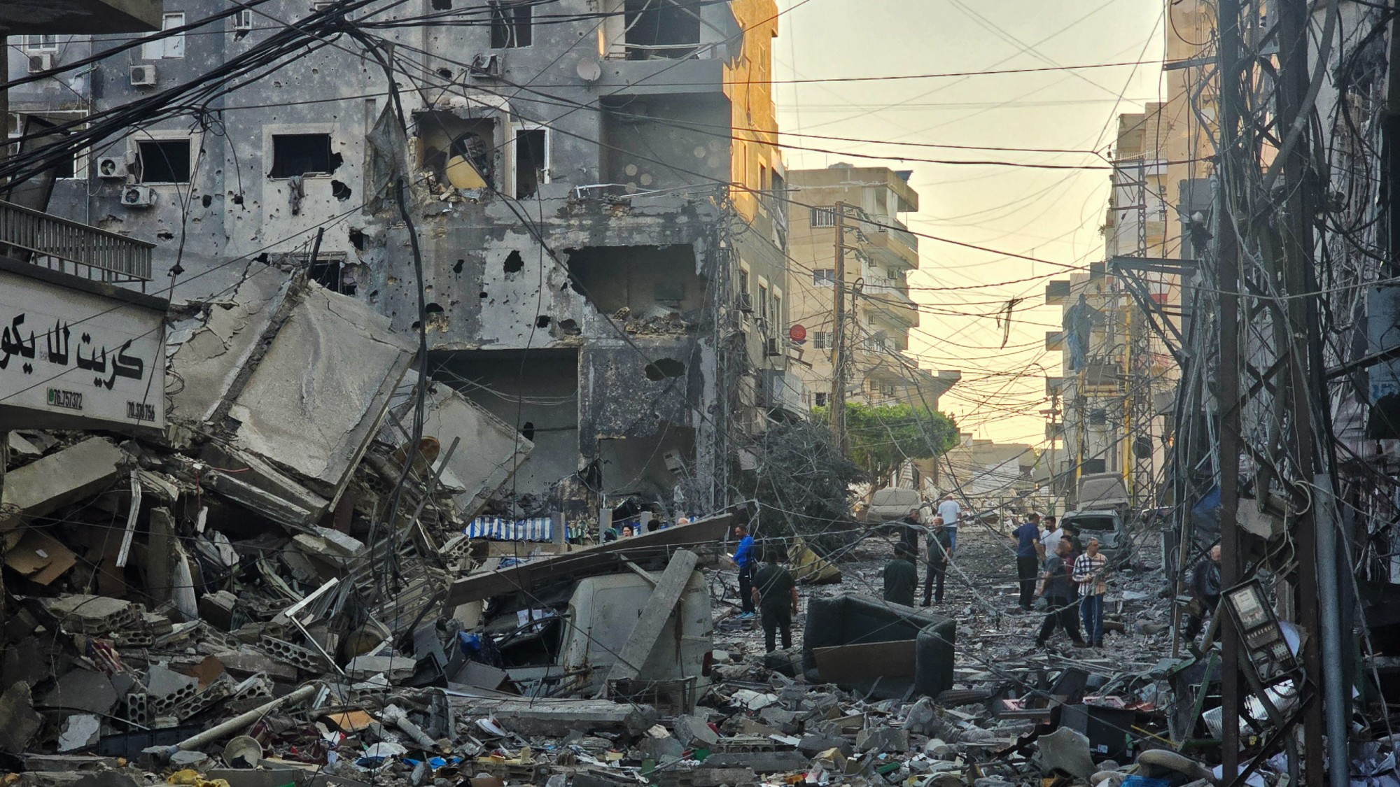 People inspect the site of an Israeli strike in the southern Lebanese coastal city of Tyre 