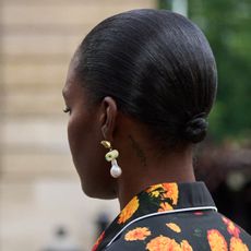 woman wearing necklaces, rings, and earrings while attending fashion week 