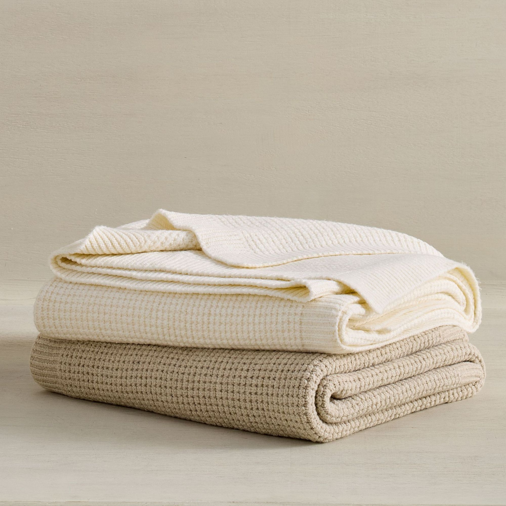 Taupe and cream knitted waffle throw blankets, folded