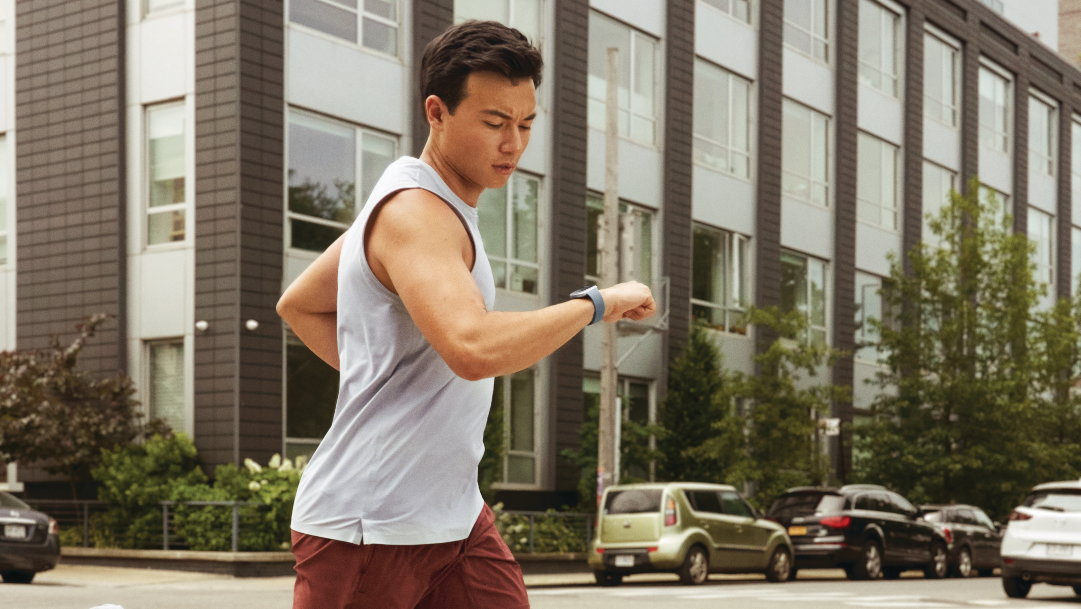 Man running with Fitbit Versa 4