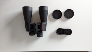 A top-down view of the binoculars and lens caps
