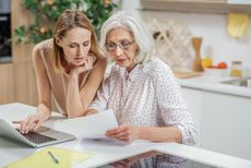 A daughter discussing important documents with her mother.